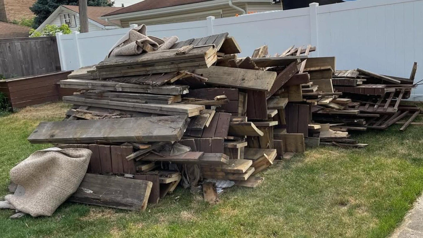 A pile of decking materials that was recently demoed sits on the lawn of a home in Chicago.
