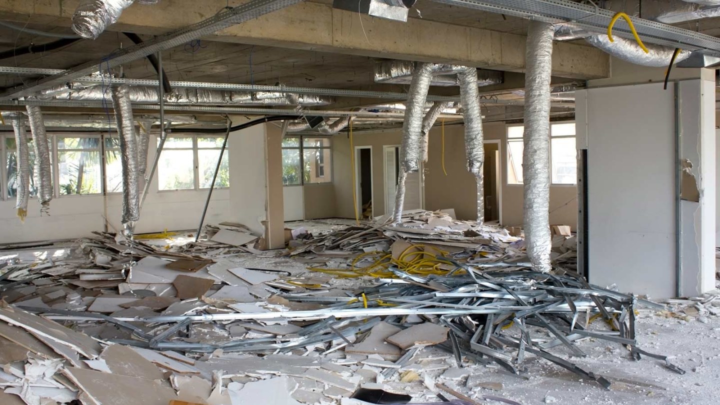 An office building is under construction ad piles of debris need to be disposed of.