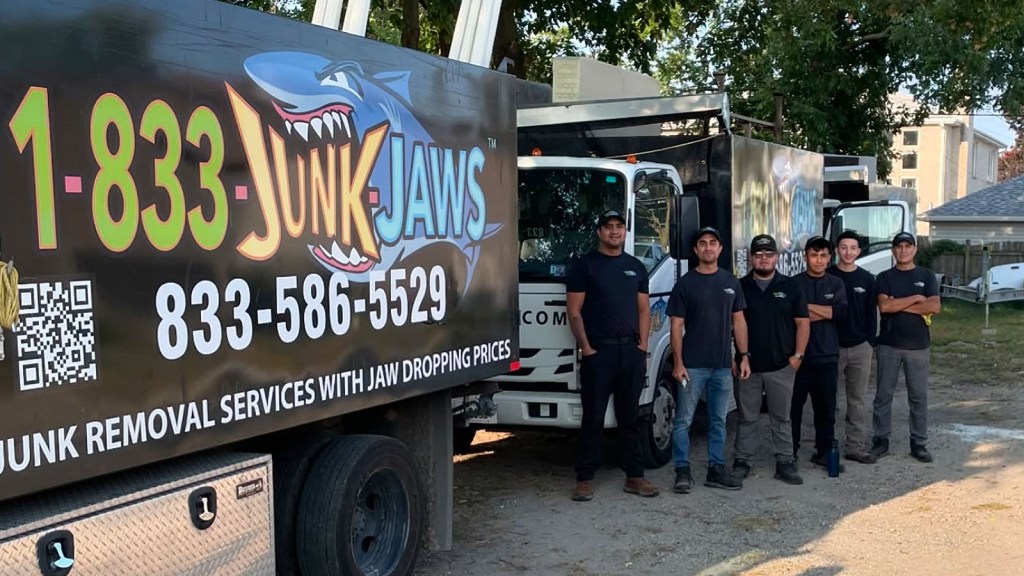 The Junk Jaws crew standing next to their junk removal trucks in Chicago