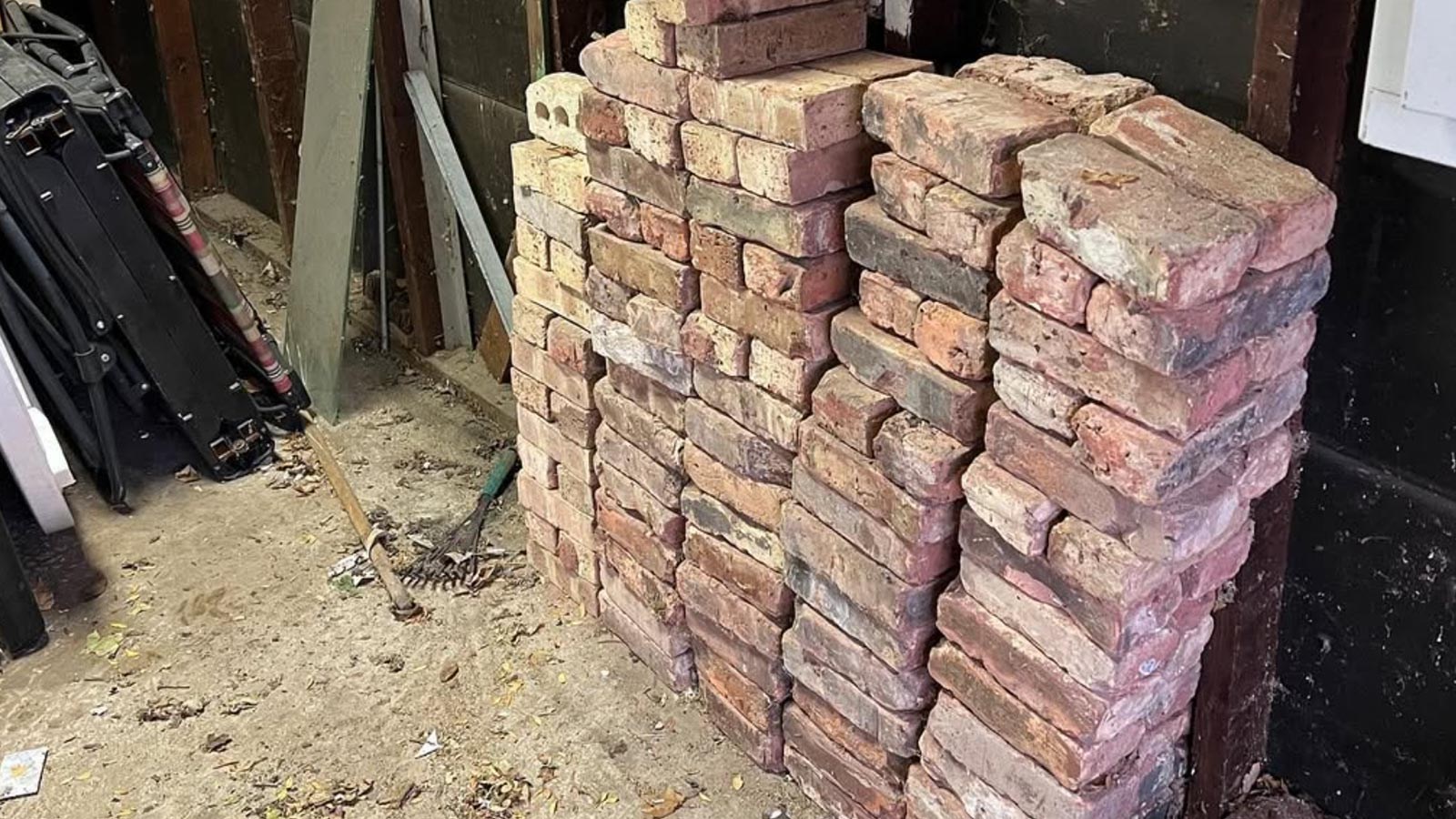 Stacks of leftover red brick from a Chicago masonry project staged for debris removal.