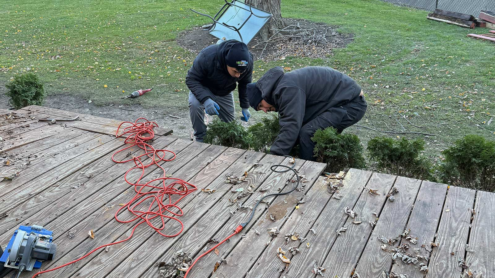 Junk Jaws crew dismantling an old backyard deck in Chicago.