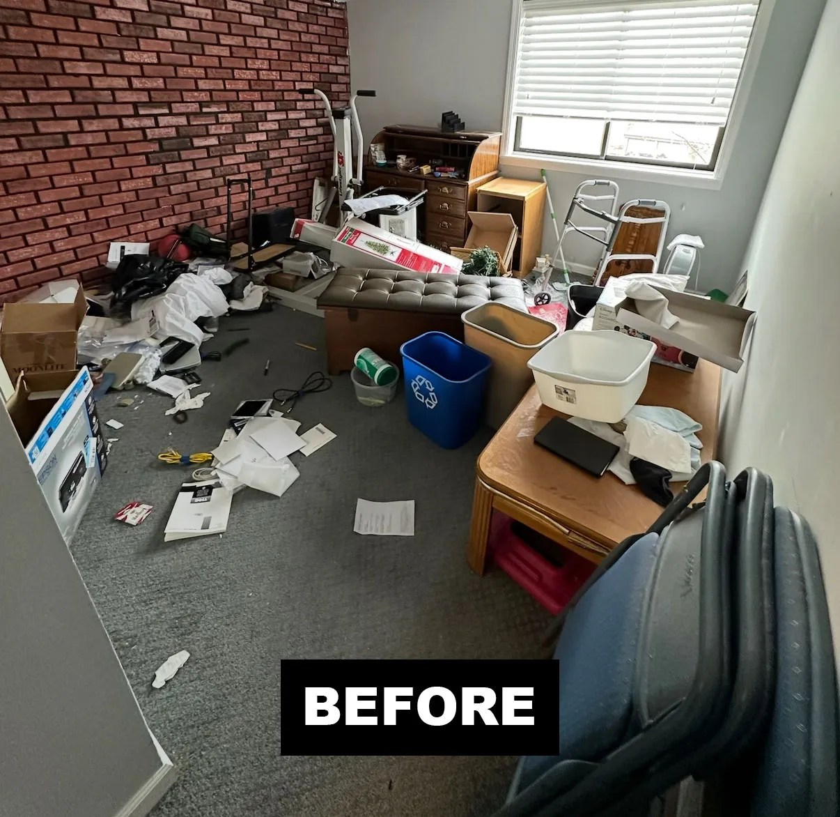 An apartment room stacked with furniture and boxes before a Junk Jaws cleanout