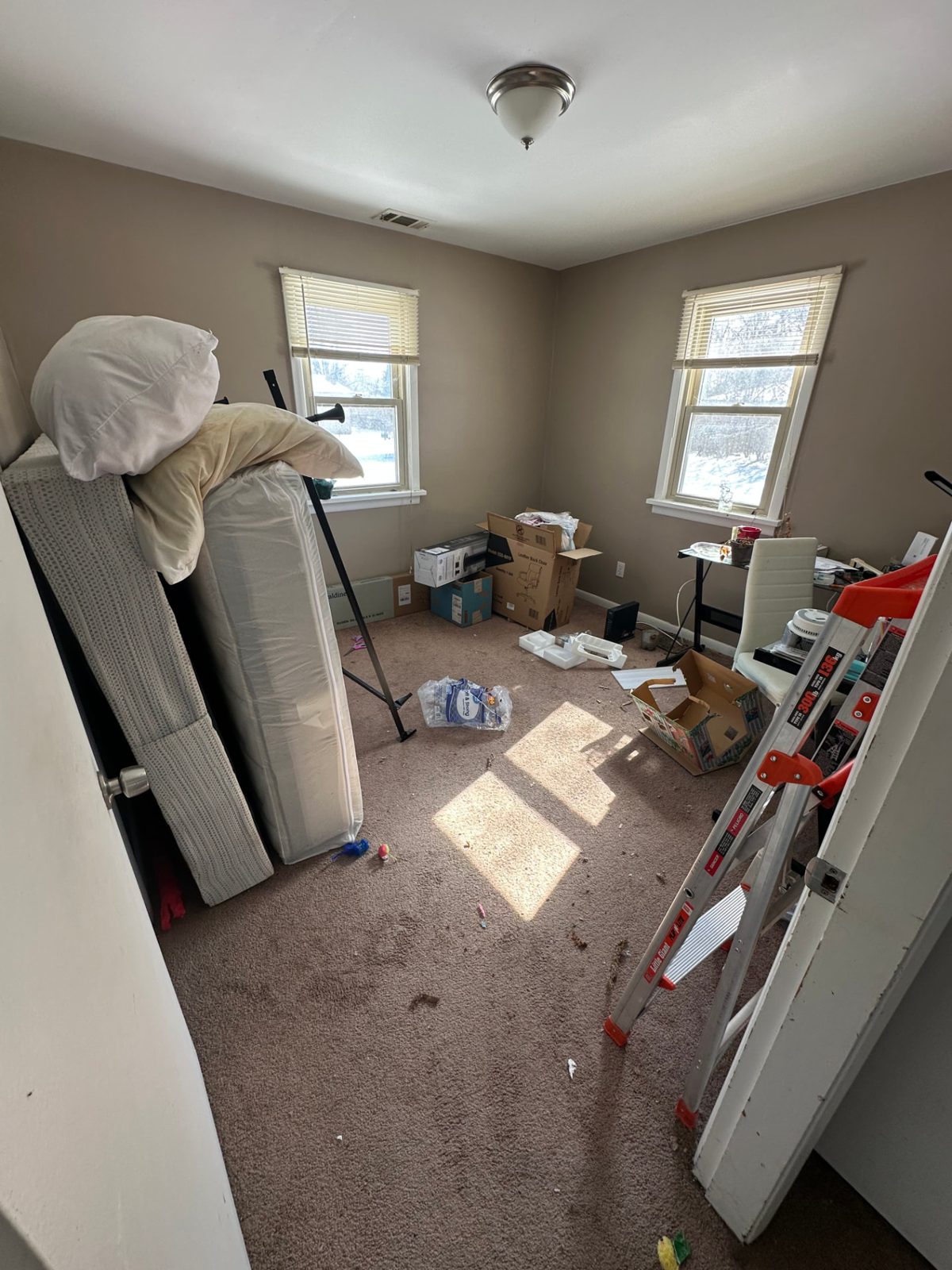 Mattress and box spring stood up in a bedroom, ready for Junk Jaws to carry out.