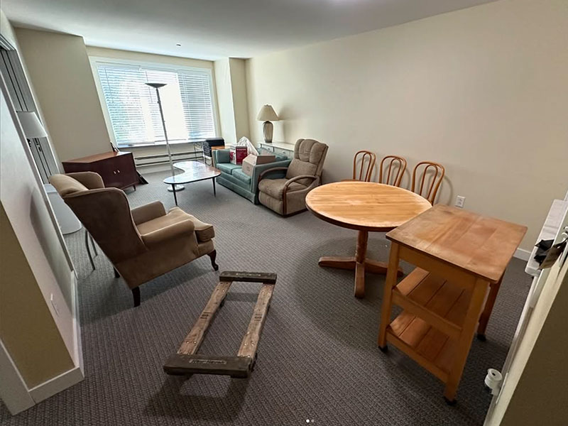 A living room filled with furniture and boxes before the Junk Jaws crew arrived