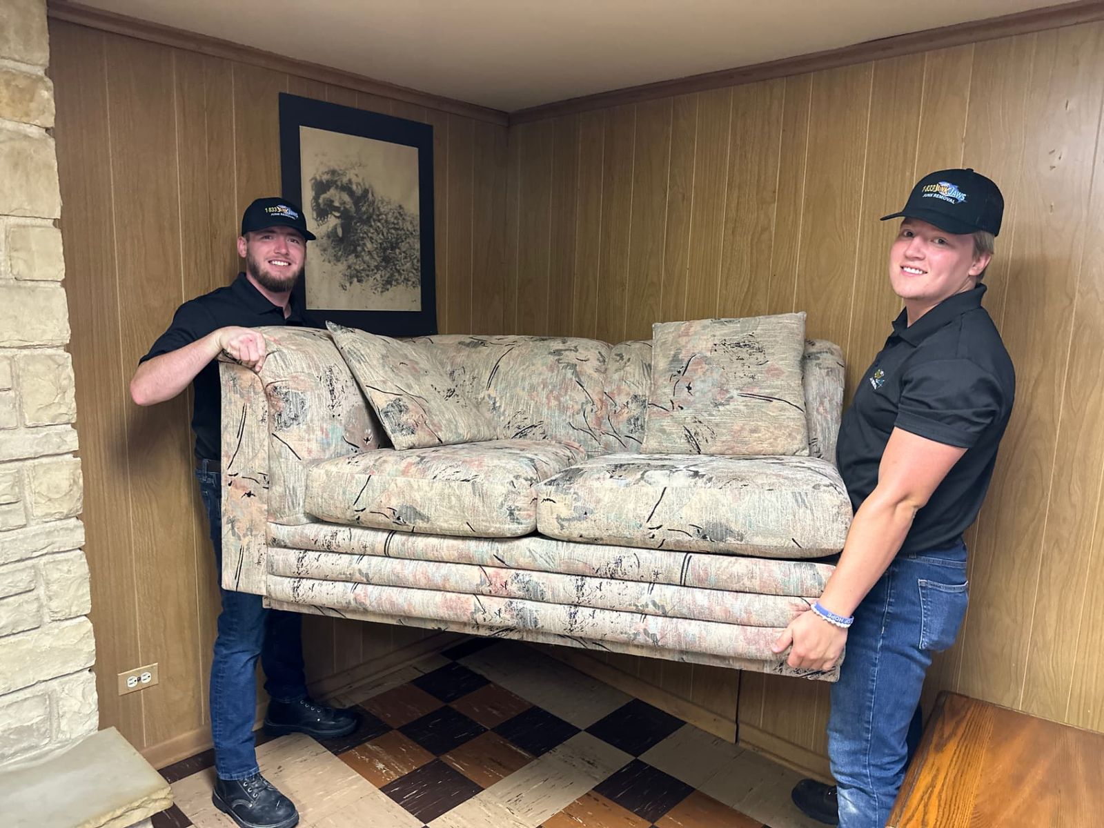 Junk Jaws crew carrying a couch out of a home.