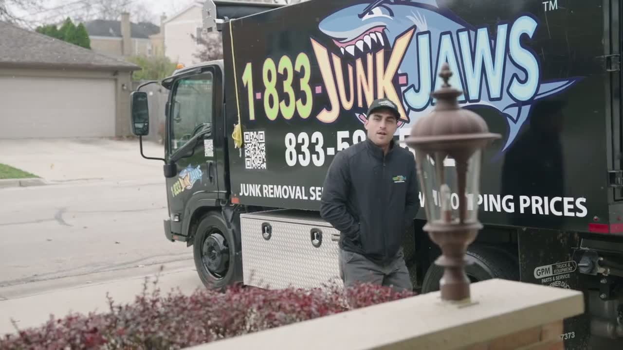Junk Jaws crew member beside a branded junk removal truck in Chicago