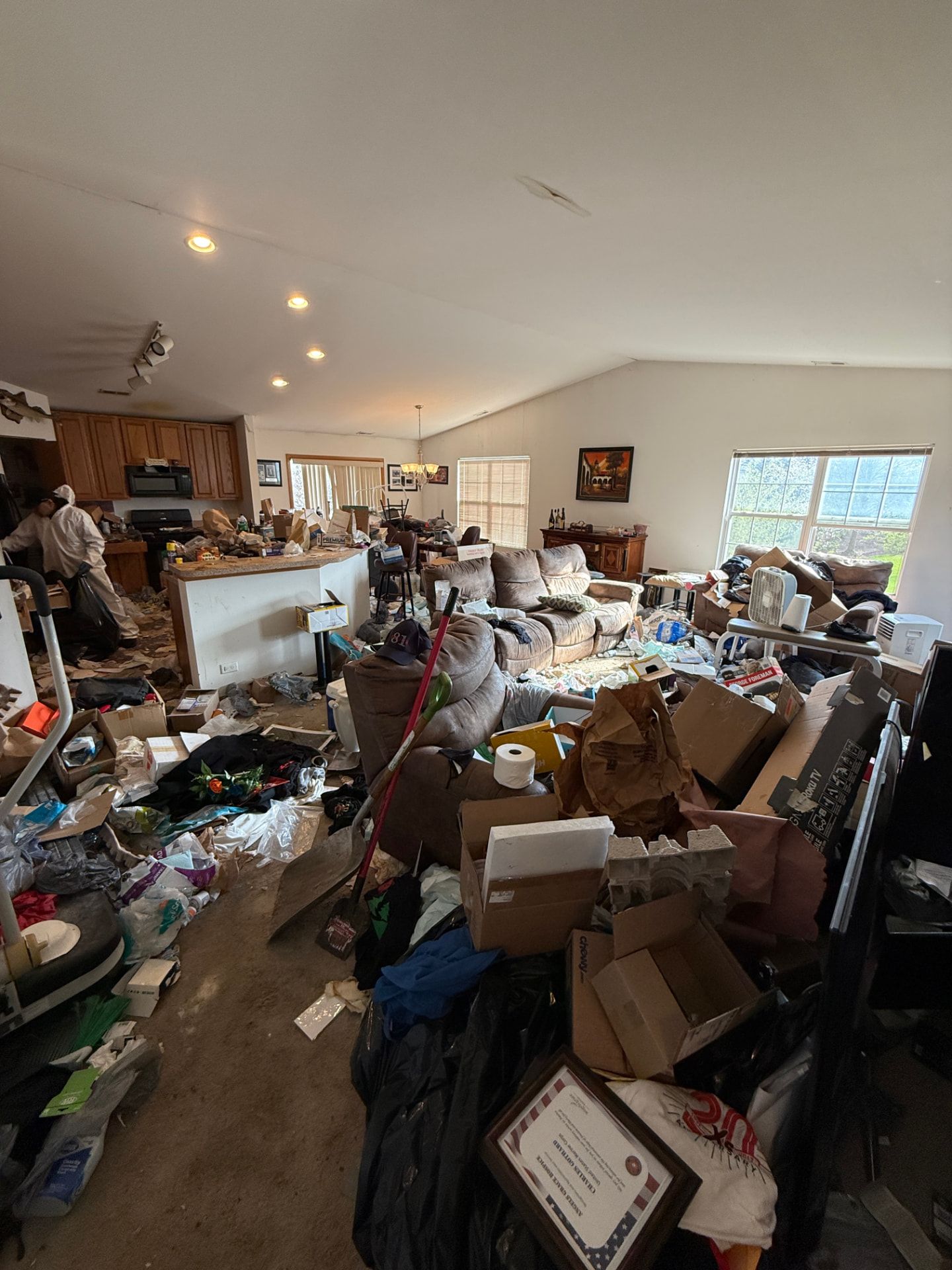 A Chicago living room packed floor to ceiling with clutter before a hoarding cleanout.