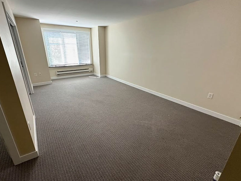 The same living room completely empty after the cleanout