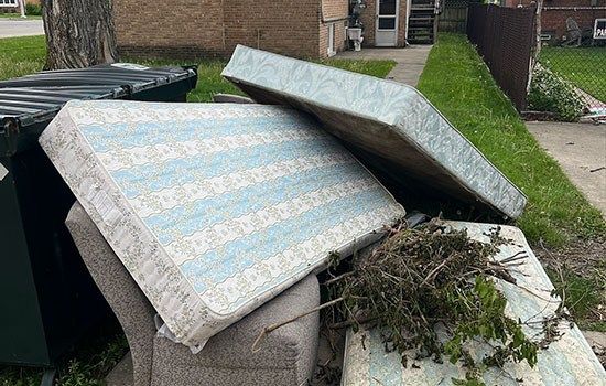 A pile of old mattresses staged for removal in Chicago