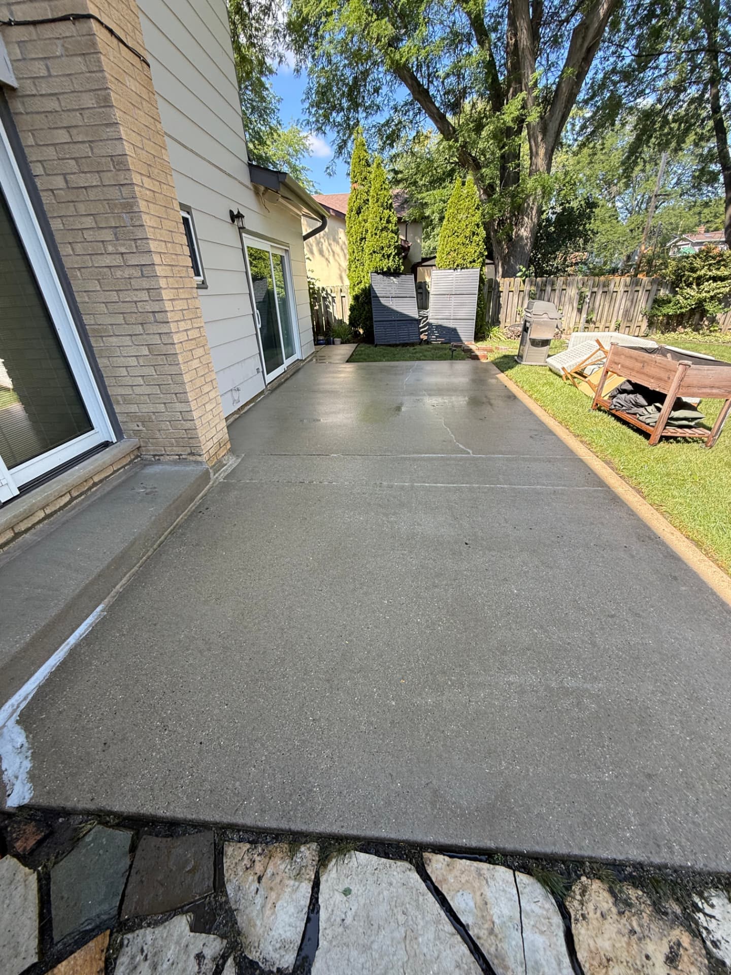 The same concrete patio after pressure washing.