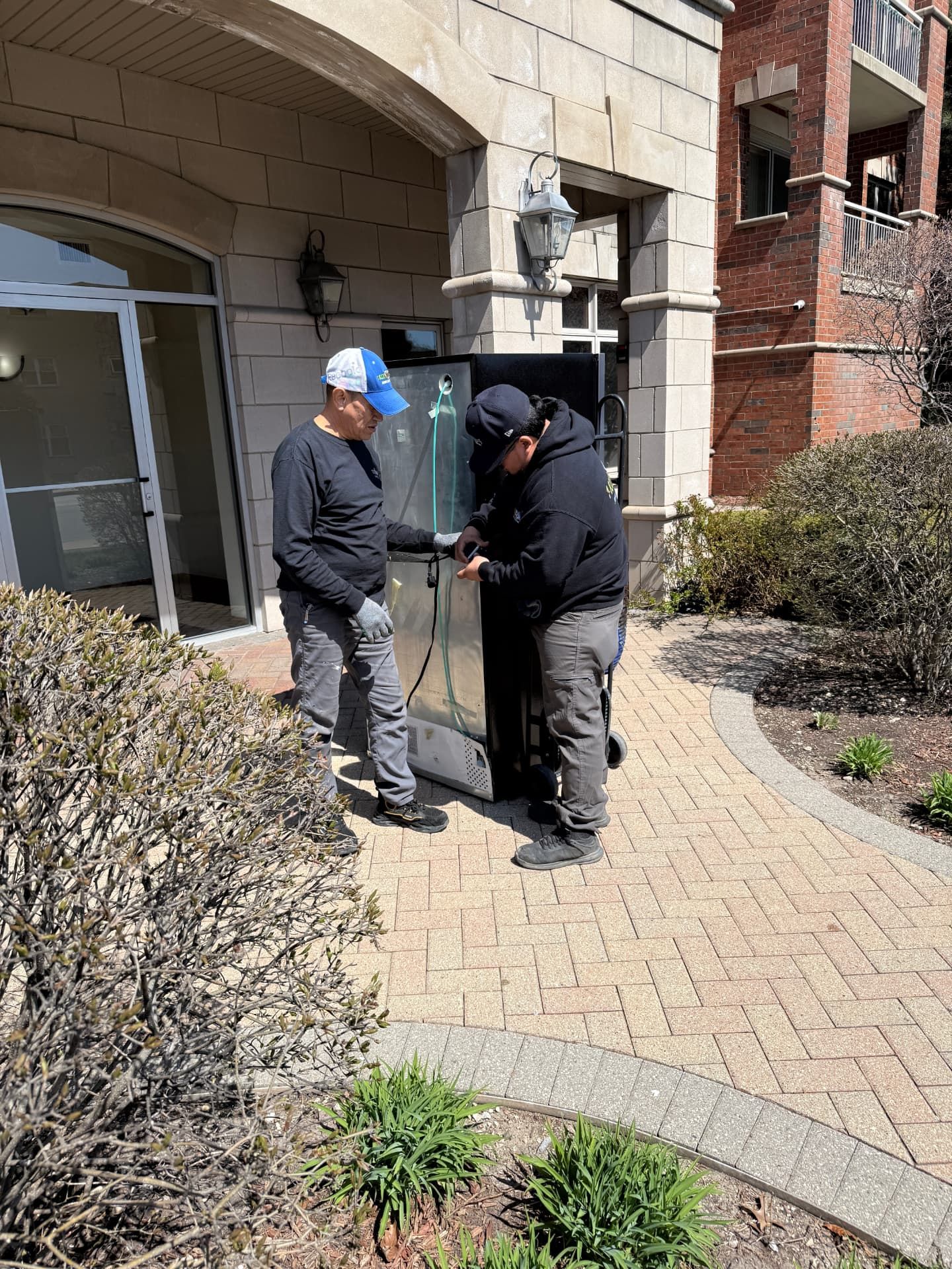 A refrigerator being removed from an apartment.