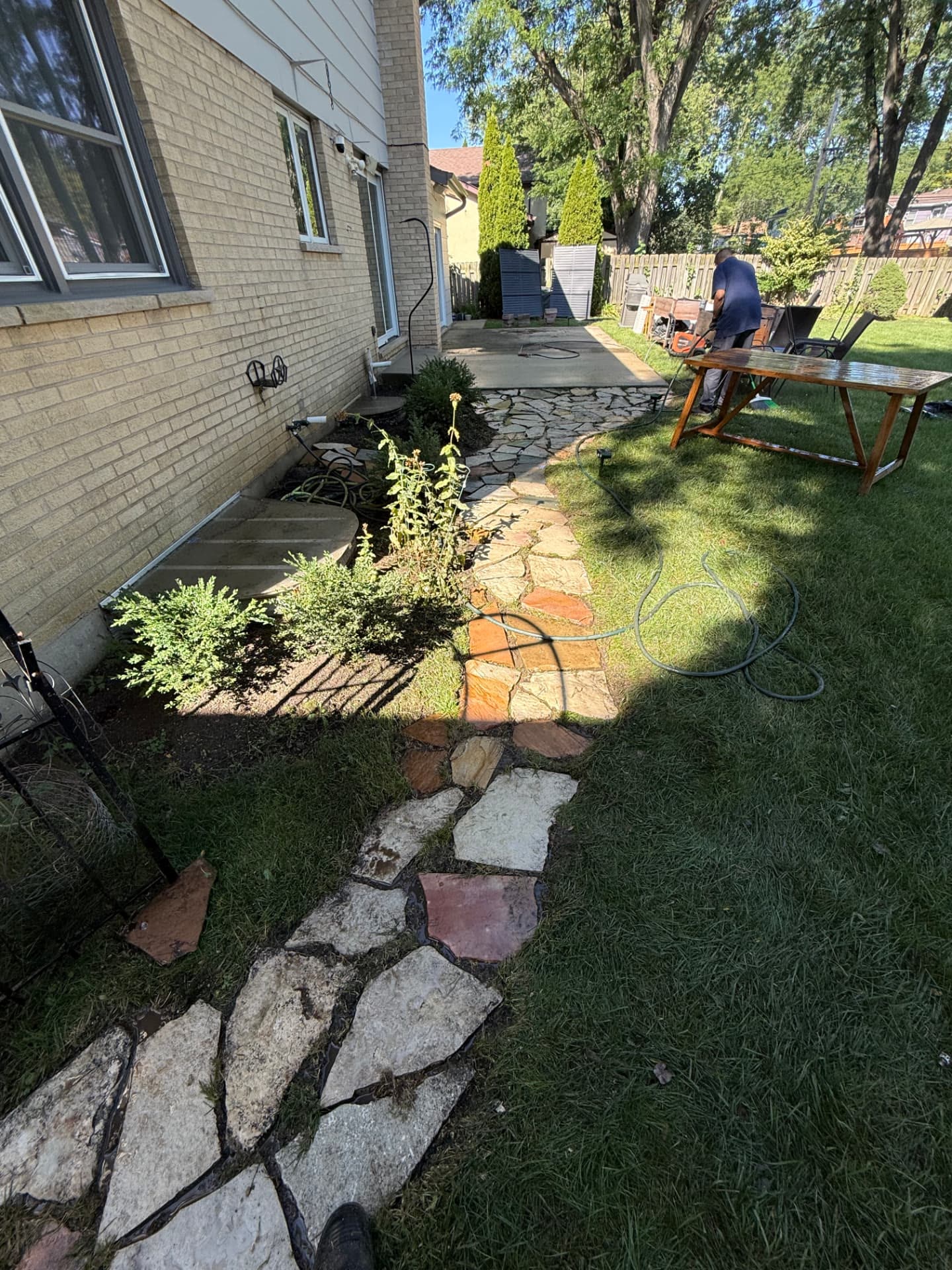 The same stone walkway and patio after pressure washing.